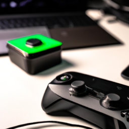 description: an xbox one controller with a rechargeable battery pack attached and plugged into a charging dock. the controller is sitting on a desk next to a gaming laptop and a headset.