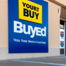 A store entrance with a Best Buy logo, and a sign with the words "Find the Best Buy near you for all your electronics and appliance needs"