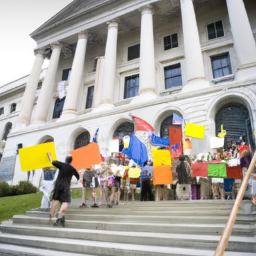 A group of people carrying signs and flags gathered outside a large building.