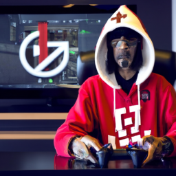 description: A photo of Snoop Dogg sitting in front of a computer, wearing a FaZe Clan hoodie and holding a gaming controller. There is a FaZe Clan logo on the computer screen in the background.