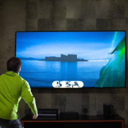 description: an image showing a person playing xbox series x on a large screen tv. the tv is mounted on a wall and displays a vivid and detailed gaming scene.