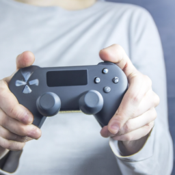 description: a person holding a game controller with a blank screen in front of them, suggesting the potential for new gaming experiences and innovation.