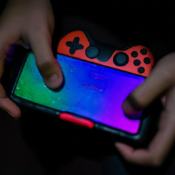 description: an anonymous image depicts a person holding a handheld game console with a vibrant screen displaying a captivating game scene. the person's hands are gripped firmly around the console, showcasing the portability and ease of use. the image captures the essence of portable gaming and the excitement it brings.
