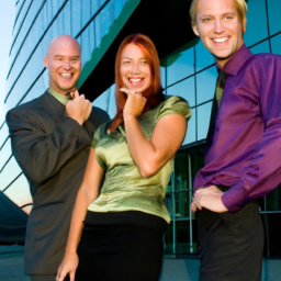 description: an anonymous image featuring three individuals with mischievous smiles, standing in front of a modern office building.